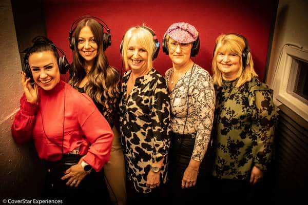 A photo of a group of ladies with headphones on